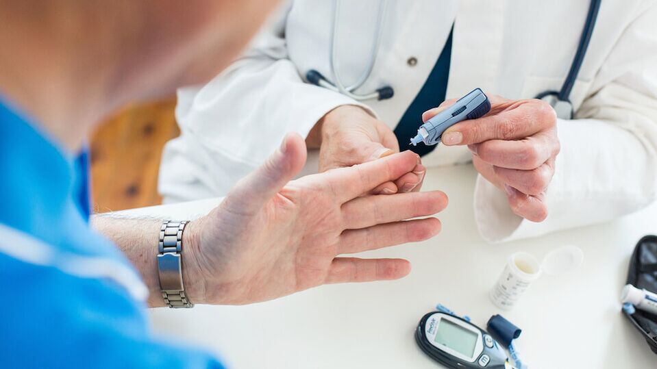 Doctor taking blood for blood sugar in diabetes